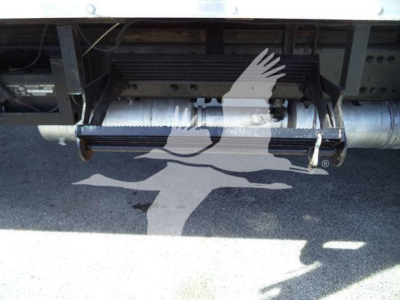 Freightliner M2 106 undercarriage showing air intake/step area with metal components and wiring visible.