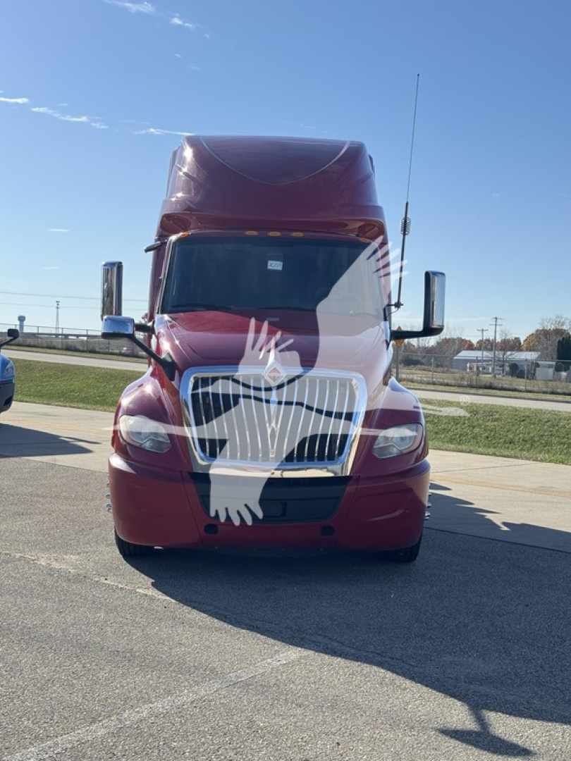 Front view of a red 2018 International LT conventional sleeper truck showing grille, headlights, and tall cab with mirror caps.