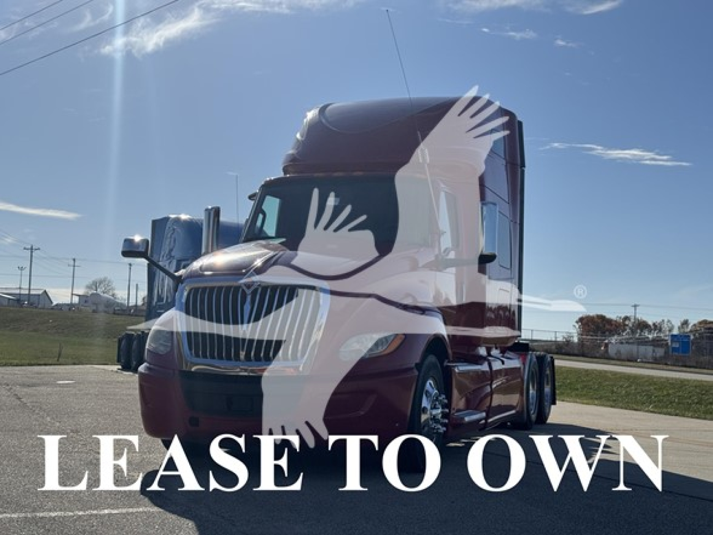 Truck cab front and side view showing a maroon 2018 International LT with 'LEASE TO OWN' overlay text in white across image.