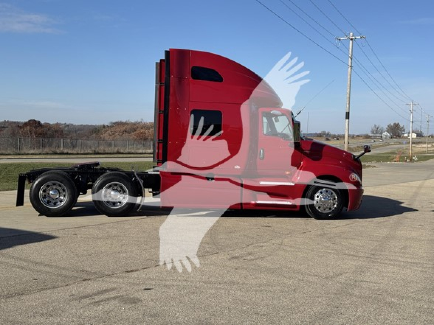2018 International LT conventional sleeper truck in red, side profile, with twin rear axles and high sleeper cab, parked on pavement.