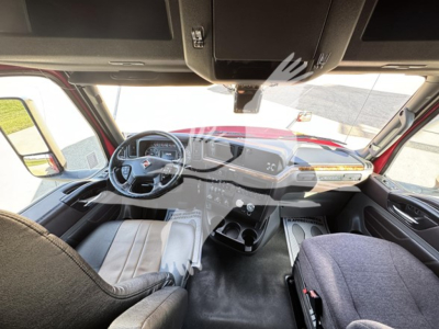 Interior view of an International LT truck cab showing steering wheel with dashboard controls and center console.