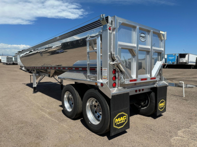 Mac Macsimiser dump trailer showing polished aluminum hopper with twin rear axles and MAC branding mud flaps.