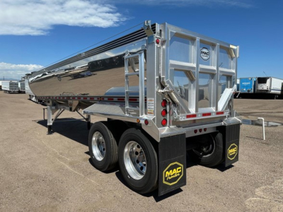 Mac Macsimiser half round aluminum end dump trailer with chrome finish, rear doors, tandem axles, MAC decals on mud flaps, and dual rear lights.