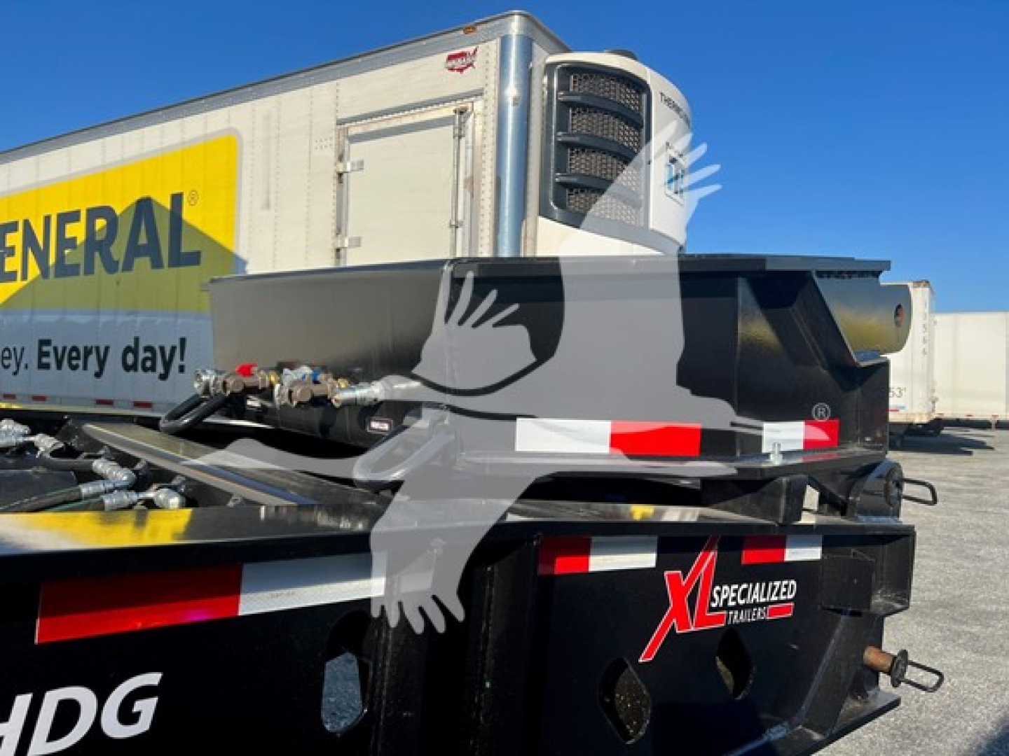 Trailer hitch area of a 2024 XL Specialized flip neck classic narrow trailer showing hydraulic components and refrigeration unit at front.