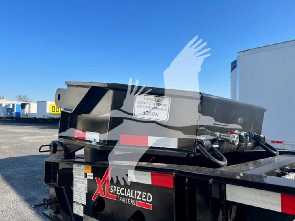 Trailer with flip neck and narrow body showing rear end and hydraulic components, XL Specialized Trailers branding visible on bumper.