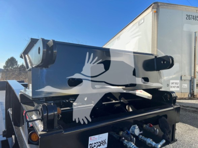 Trailer hitch showing flip neck component with hydraulic lines and steel frame, part of a XL Specialized Double Drop Expandable trailer in new condition.