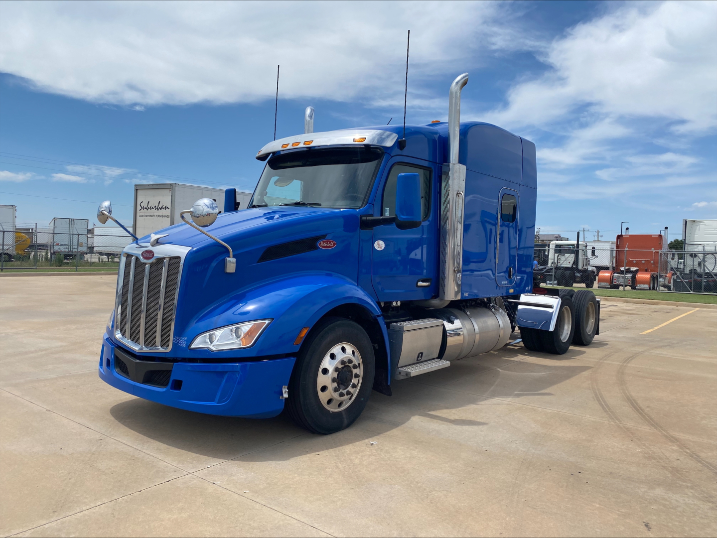 Peterbilt 579 truck in blue, side view, with sleeper cab and chrome exhaust stacks. No visible labels or stickers readable.