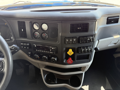 Peterbilt 579 truck dashboard and center console with gauges, switches, and cup holder area.