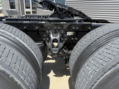 Peterbilt 579 truck chassis showing rear axle suspension and undercarriage, dual rear wheels, frame rails, and mounting hardware.