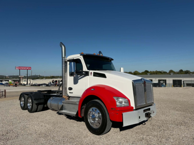 Kenworth T880 daycab truck in white and red with chrome exhaust stack, front grille and wheels, 6x4 tractor chassis, side view showing cab and fuel tanks.