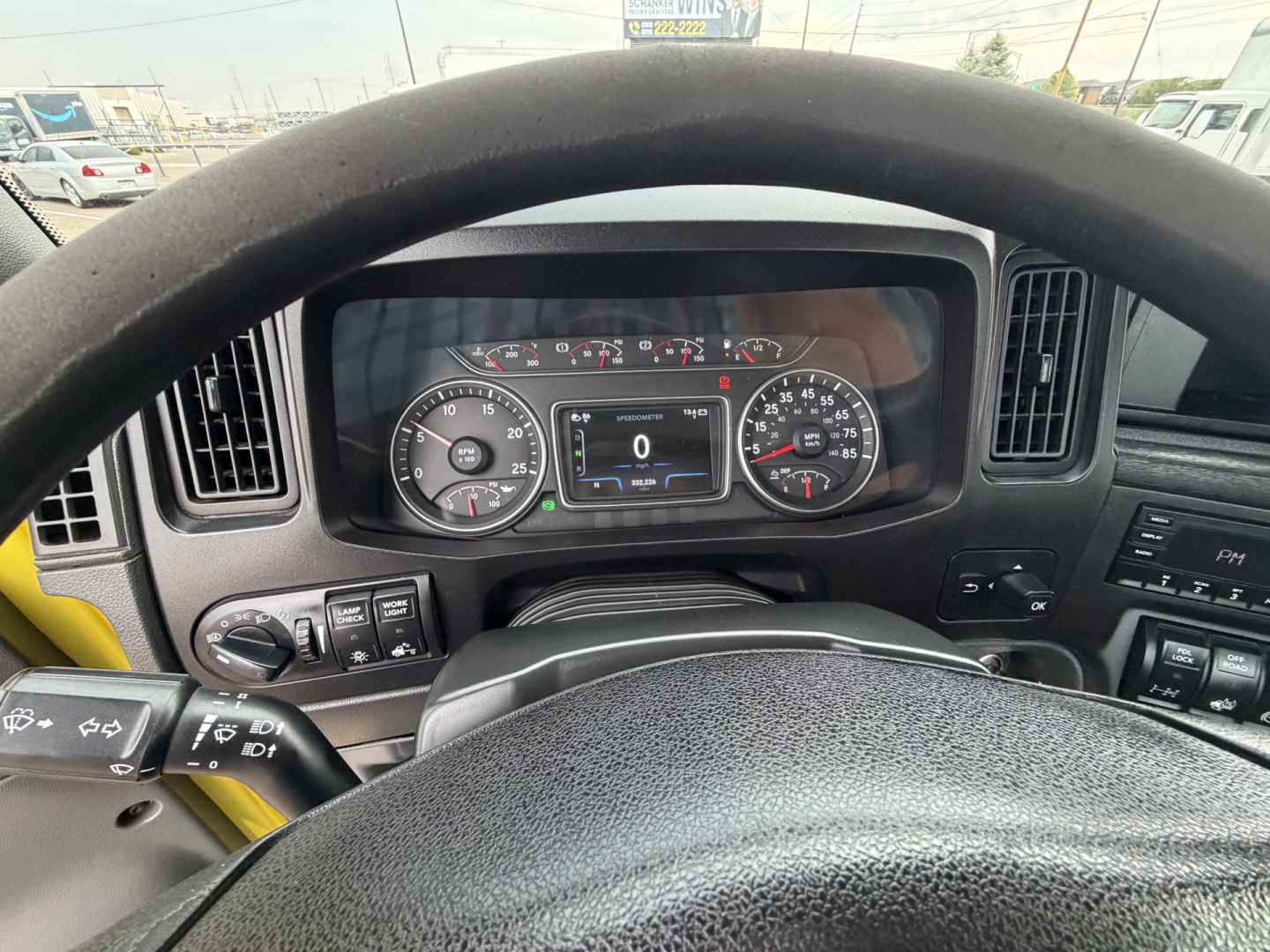 Dashboard view from the driver seat of a 2023 International LT625 daycab showing instrument cluster and steering wheel.