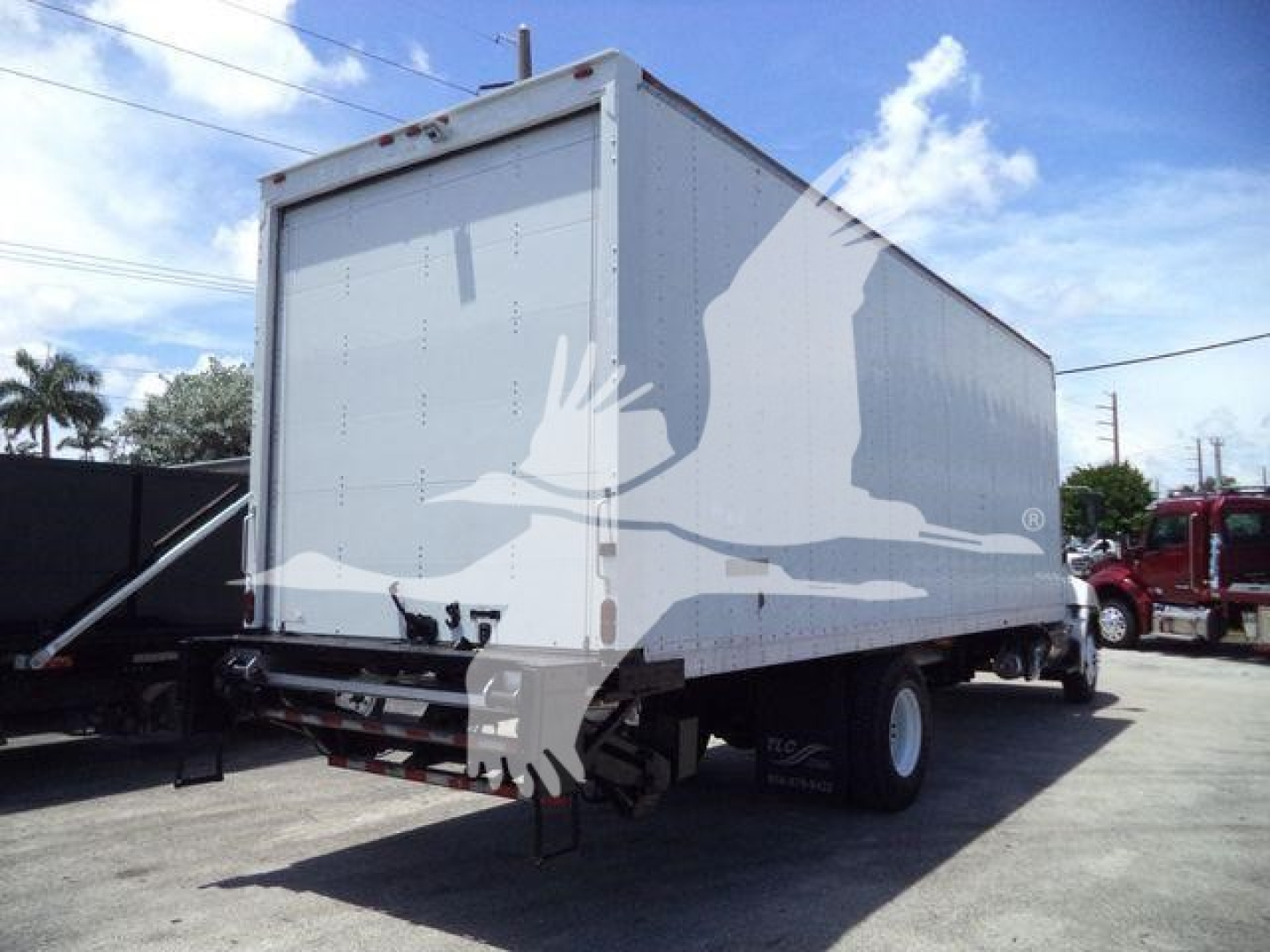 Box truck rear and side view showing cargo box and dual rear wheels of a 2020 Hino 268A used truck.