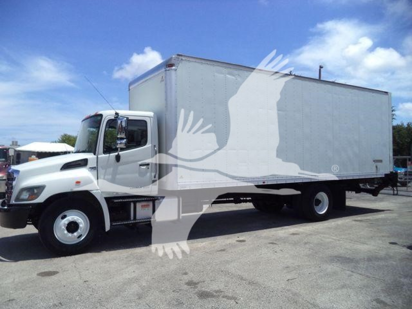 Box truck 2020 Hino 268A side view showing cab and large box cargo area.