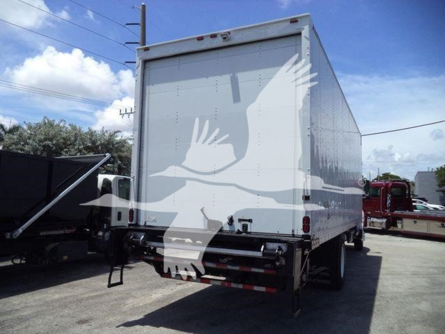 Hino 268A box truck rear view showing cargo box and rear bumper with reflective tape.