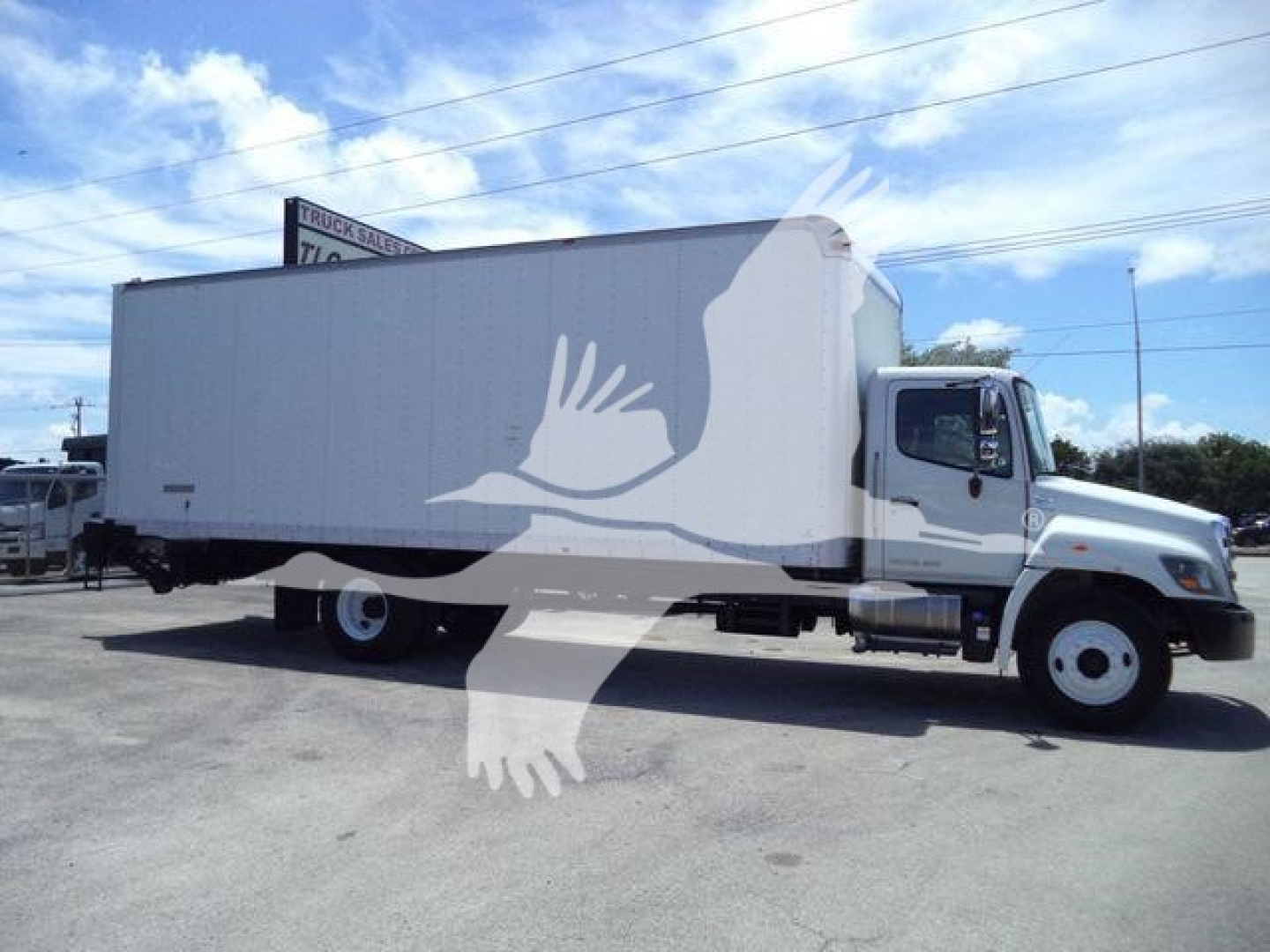 Hino 268A box truck in a parking lot with a large white box body and cab, stock number T59378, VIN visible
