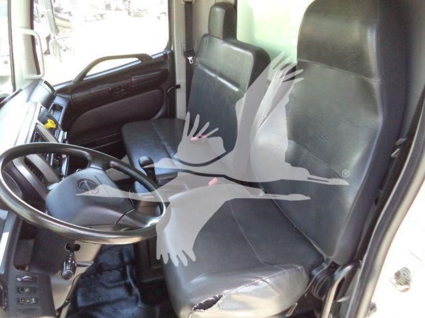 Cab interior of a 2020 Hino 268A box truck showing driver seat and passenger seat with steering wheel and dashboard visible.
