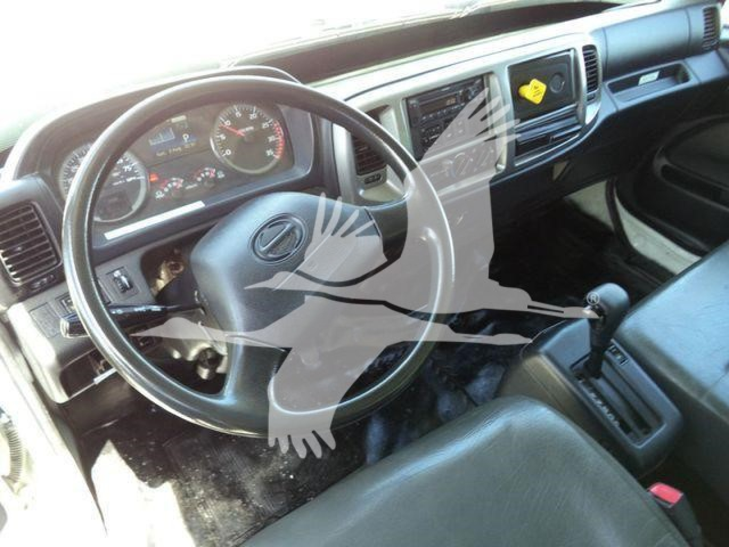 Hino 268A cab interior showing steering wheel dashboard gear selector and driver seat with instrument cluster