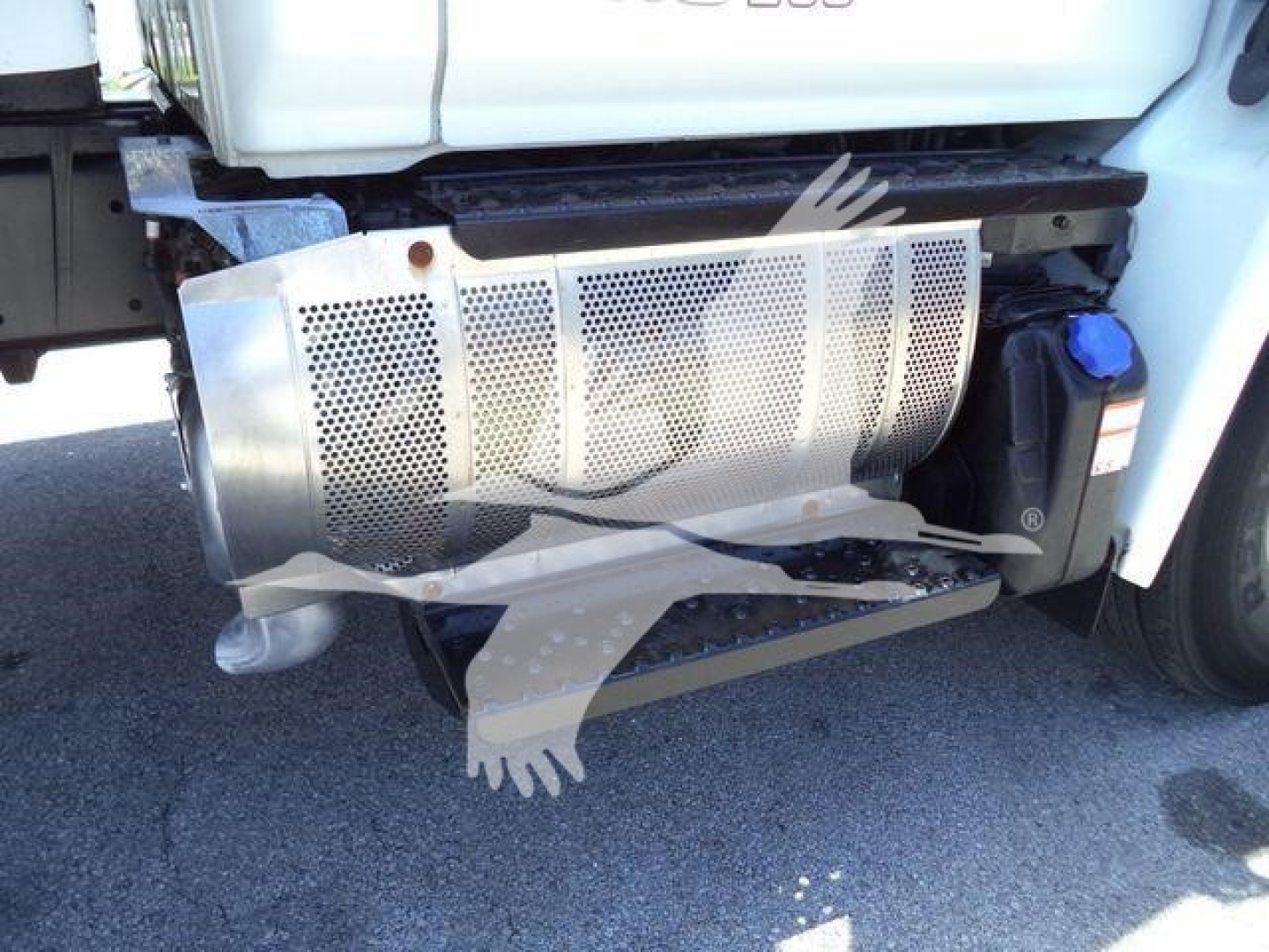 Truck side showing exhaust/muffler and underbody components of a 2020 Hino 268A with perforated skid plate and fuel tank area visible.