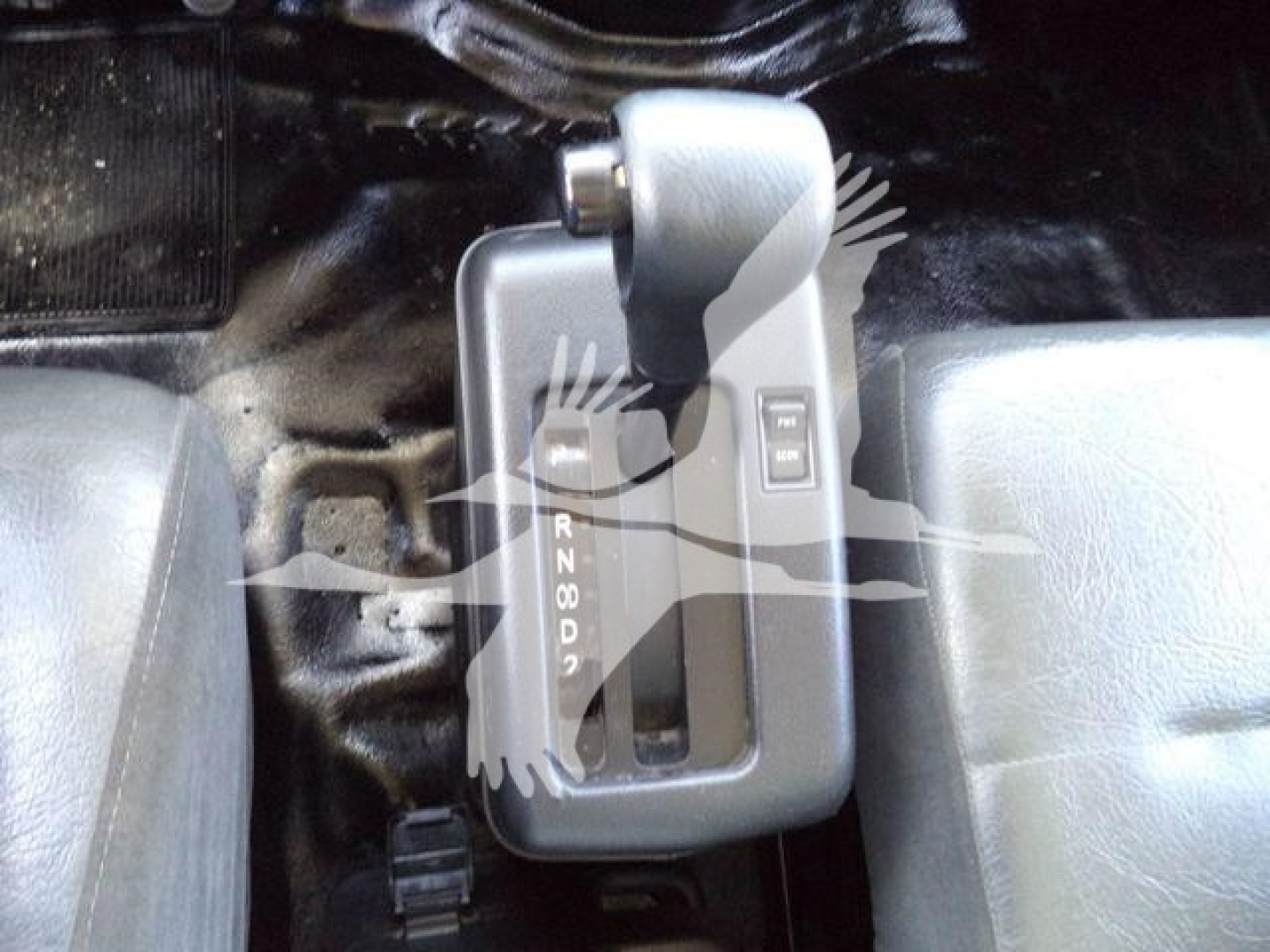 Hino 268A cab interior showing automatic shifter with gear positions PRND21 and a switch nearby.