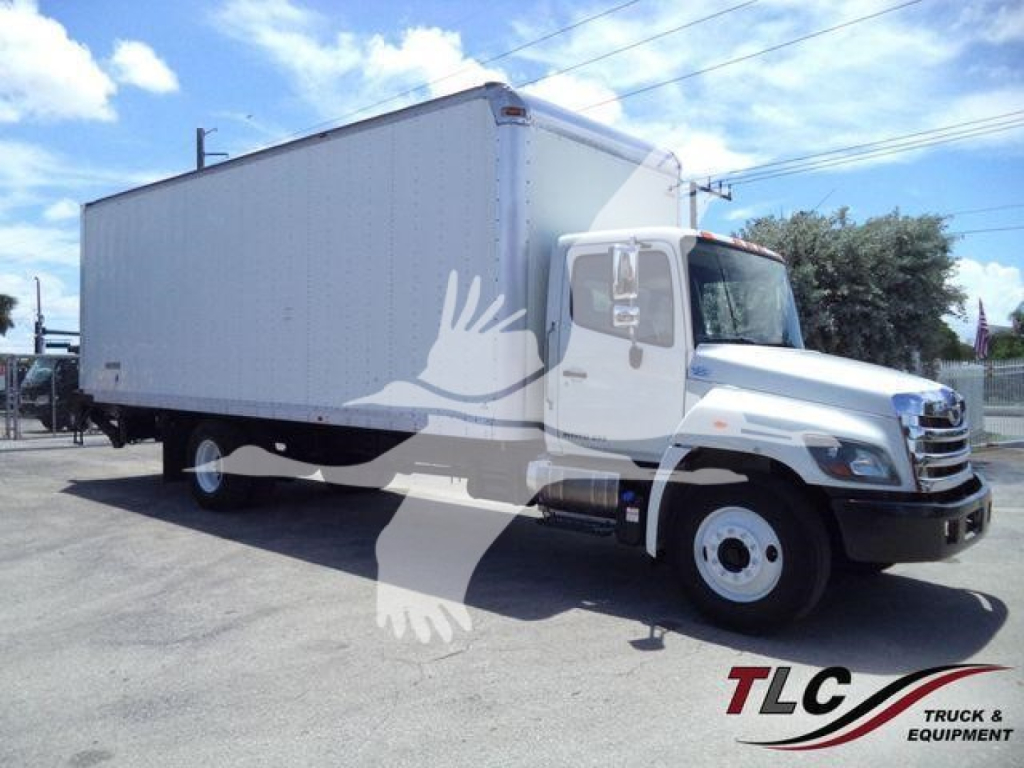 Hino 268A box truck in-service showing side view with cargo box, cab, and white wheels.