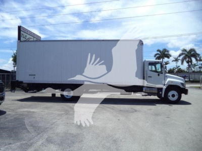 Truck box body side view showing large white container with graphic wings overlapping the cab area.