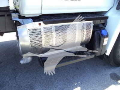 Truck side showing exhaust/muffler and underbody components of a 2020 Hino 268A with perforated skid plate and fuel tank area visible.