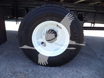 Wheel with Continental tire on a white steel rim; faint text on tire sidewall