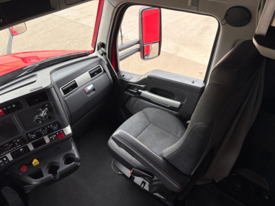 Kenworth T680 truck cabin interior view with driver seat and dashboard panels.