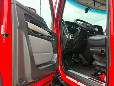 Kenworth T680 truck cab interior and doorway showing red exterior and black dashboard