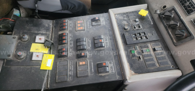 Freightliner control panel and switches in cab showing multiple switches and gauges.