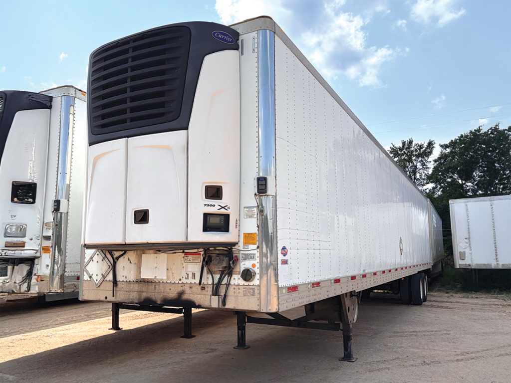 Utility reefer trailer with a front refrigerated unit and a raised nose, showing a white thermo-compressor housing and black grille; no legible branding or model text visible.