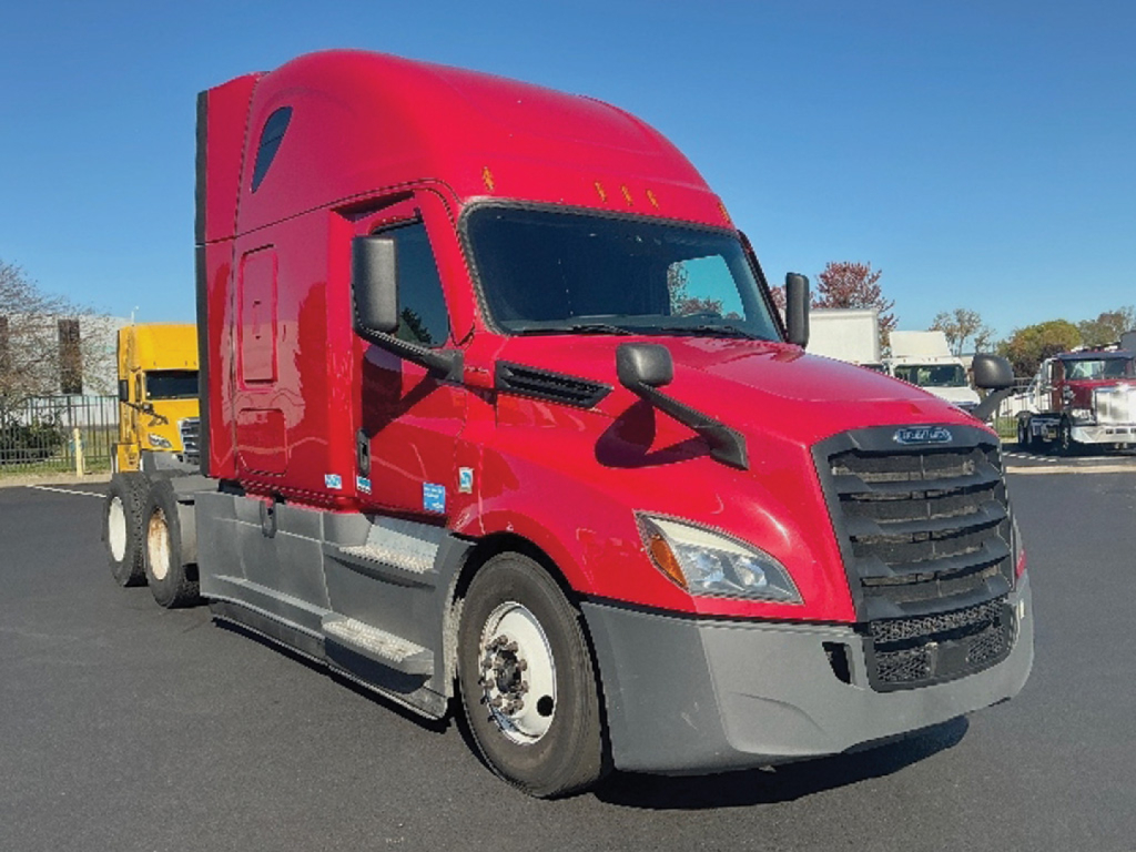 Freightliner Cascadia125/126 sleeper cab truck in red with black grille and gray bumper, front-left view showing side mirrors and aerodynamic design.
