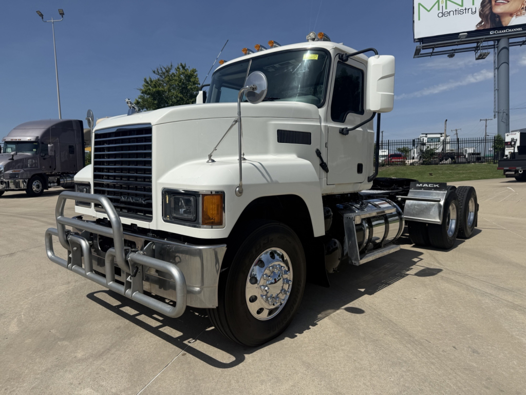 Mack PI64T conventional daycab truck in white front view showing grille guard and dual mirrors