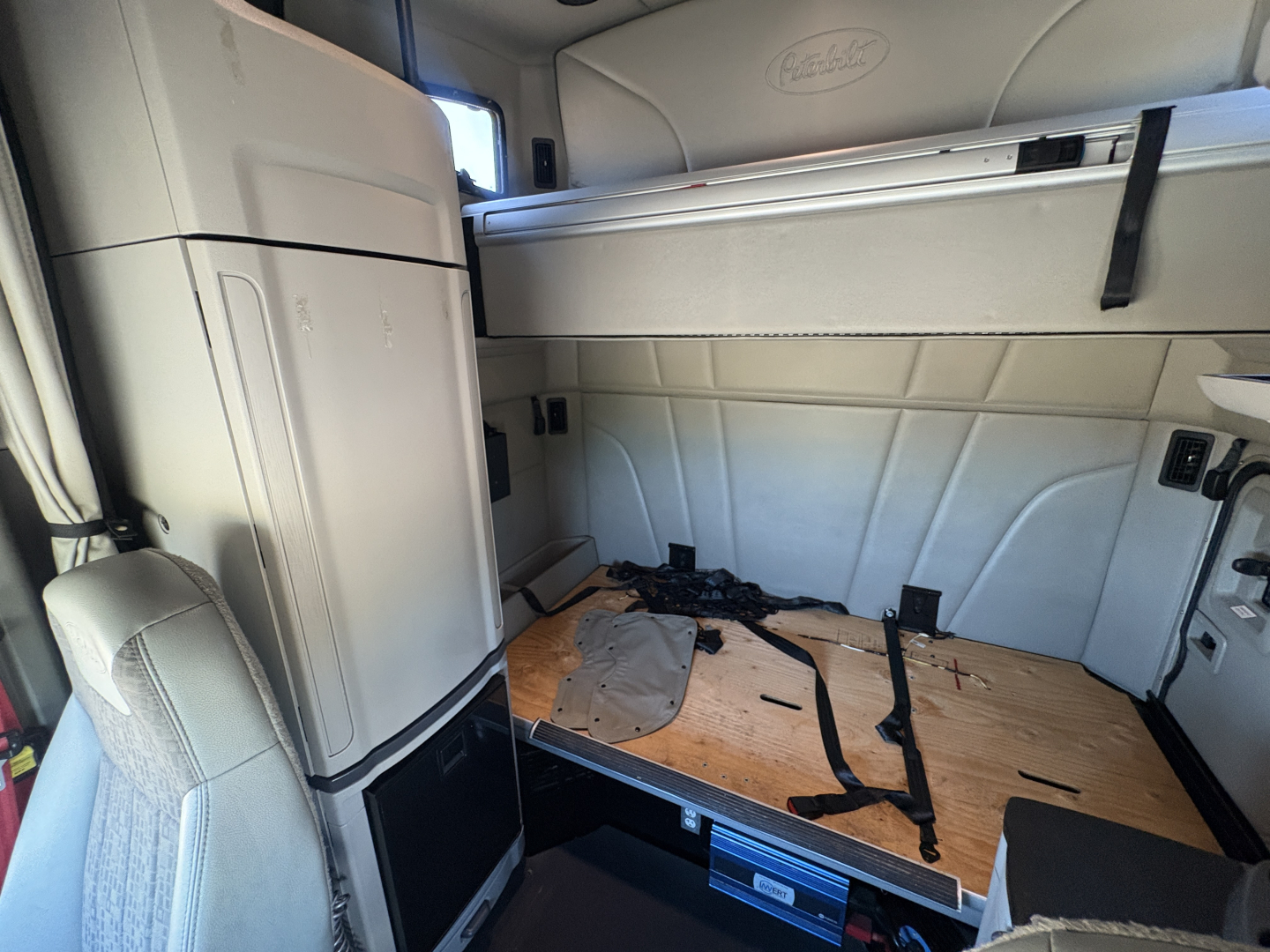 Peterbilt 579 cab interior showing sleeper area and floor panels.
