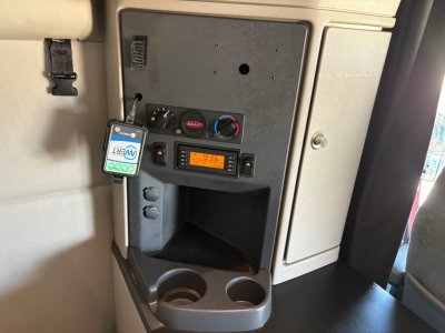 Peterbilt 579 cab interior center console with power/inverter display and cup holders visible