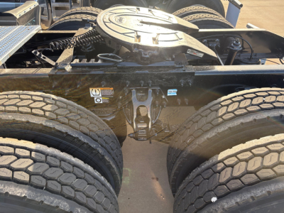 Peterbilt 579 chassis image showing dual rear wheel assembly and fifth wheel area with visible fuel/air lines and mounting hardware.