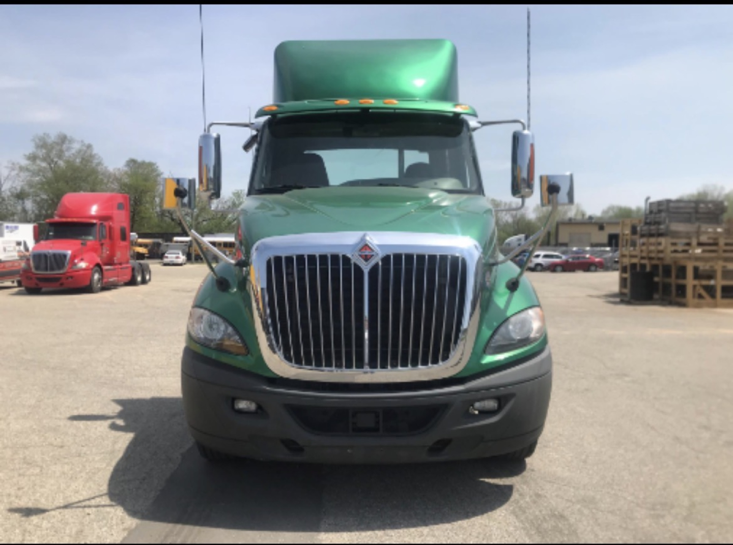Green 2017 International Prostar+ cab and chassis front view with chrome grille and black bumper.