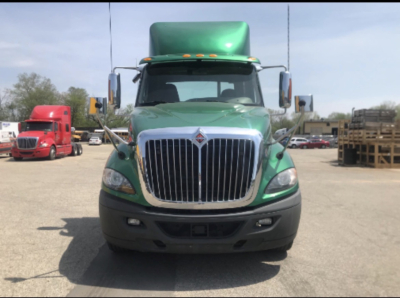 Green 2017 International Prostar+ cab and chassis front view with chrome grille and black bumper.