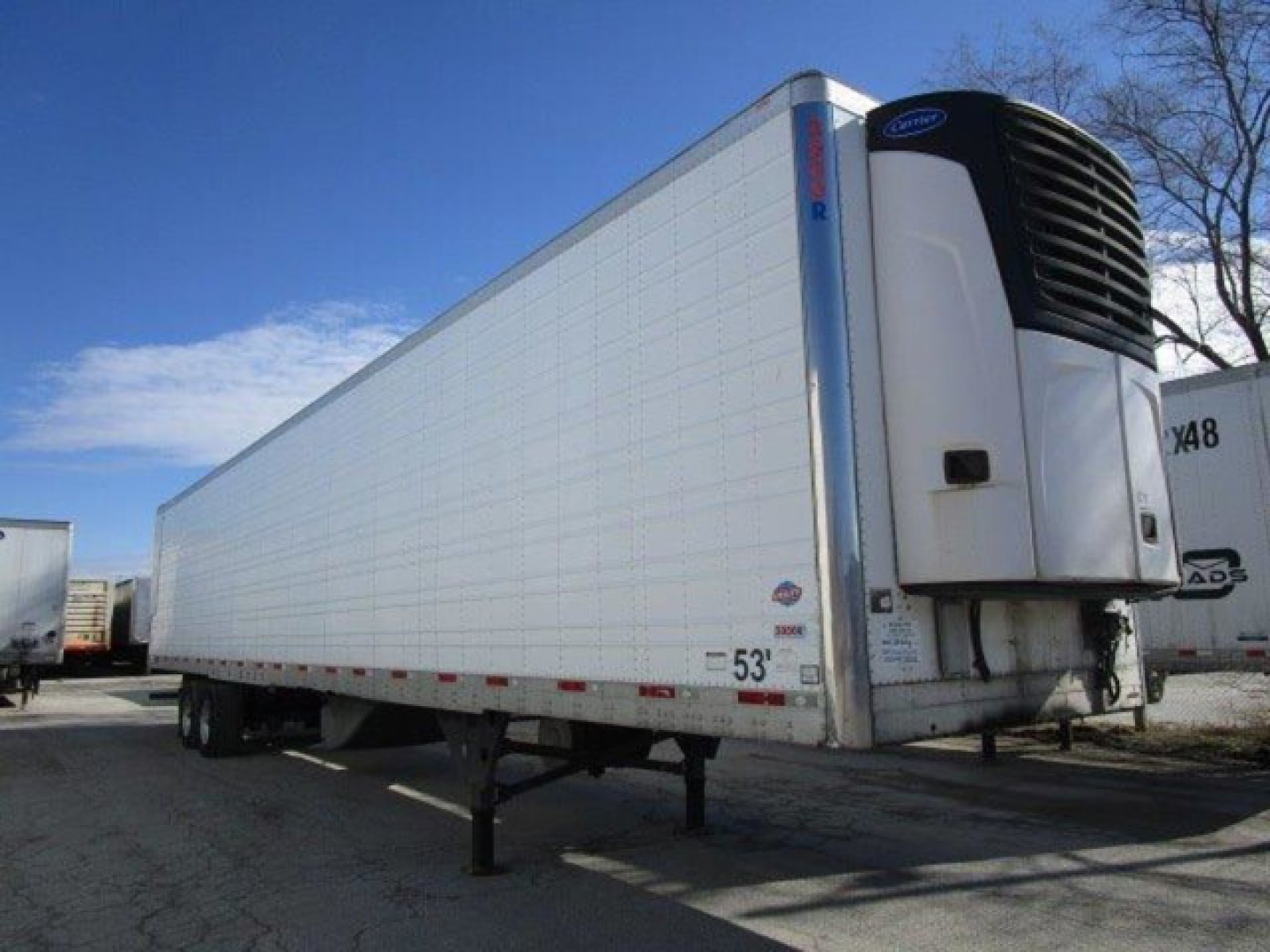Trailer side view showing a 53' refrigerated trailer with a front-mounted refrigeration unit.