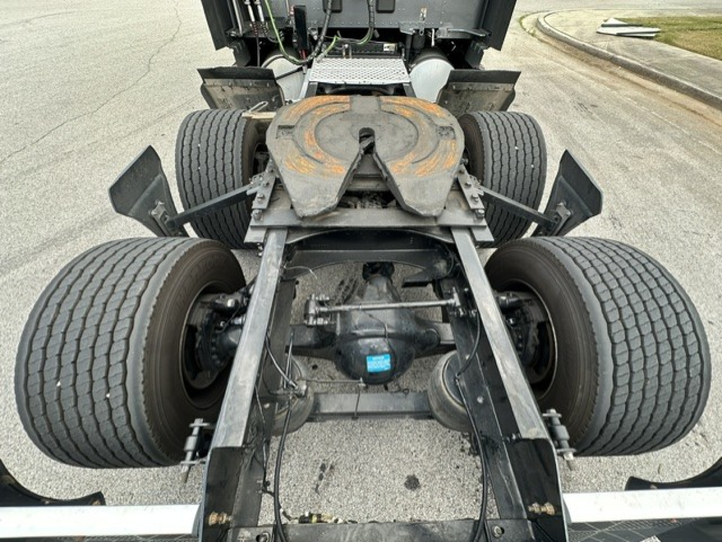 Kenworth T680 chassis and rear drive axles showing dual axles, fifth wheel, and suspension components.