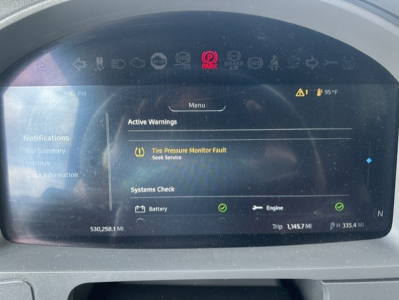 Kenworth T680 digital dashboard showing active warnings and systems check with green indicators.