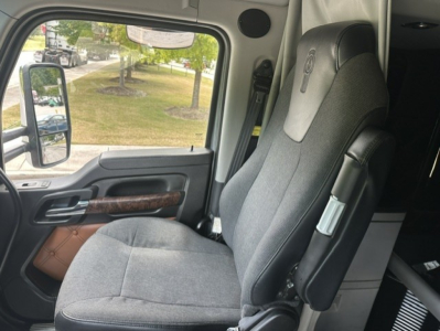 Kenworth T680 interior seat and door panel view from the driver side.