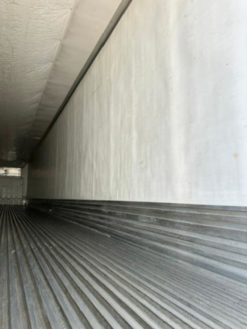 Interior of a 2016 utility reefer trailer with ribbed aluminum floor and insulated side walls.