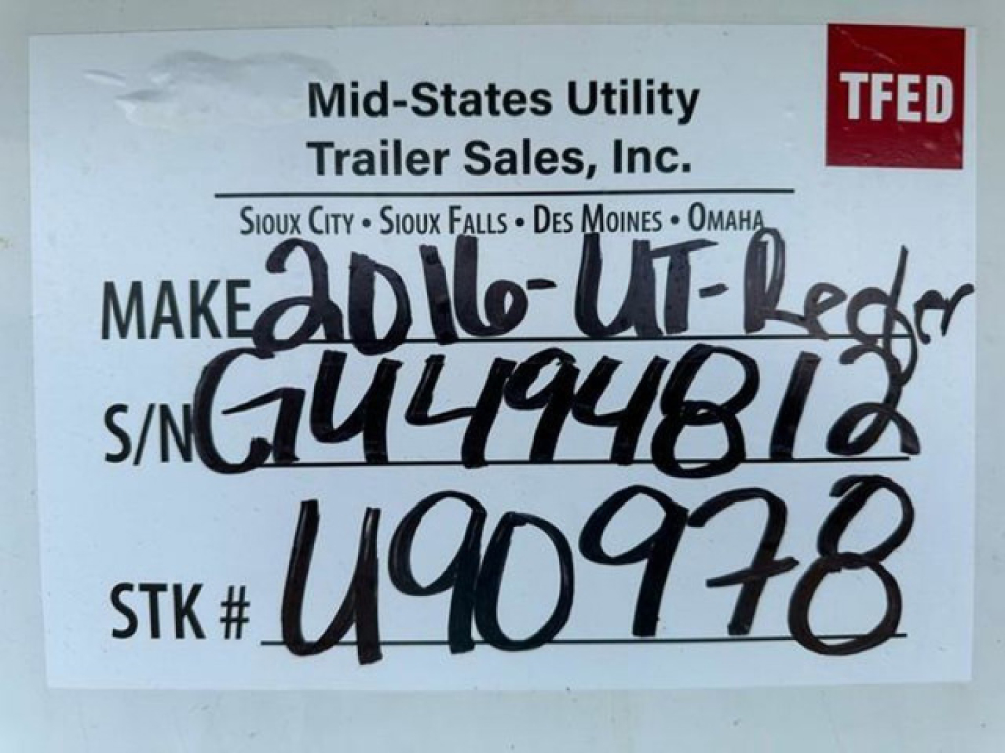 Sign showing Mid-States Utility Trailer Sales, TFED logo, handwritten stock and S/N numbers for a 2016 utility reefer trailer.
