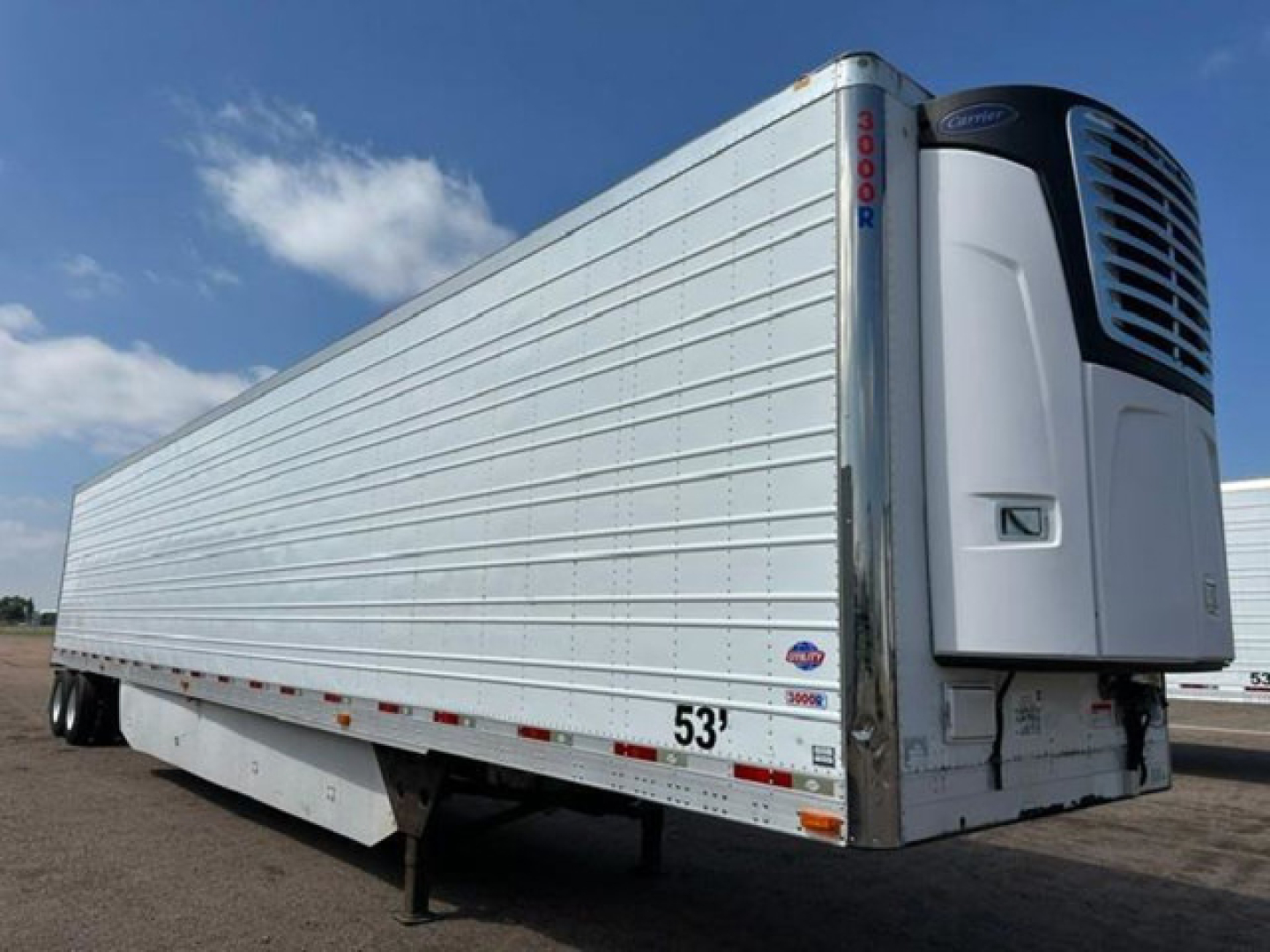 Utility reefer trailer with 53 ft length and a front refrigeration unit, white metal sides, silver vertical corner posts, and labeling near rear.