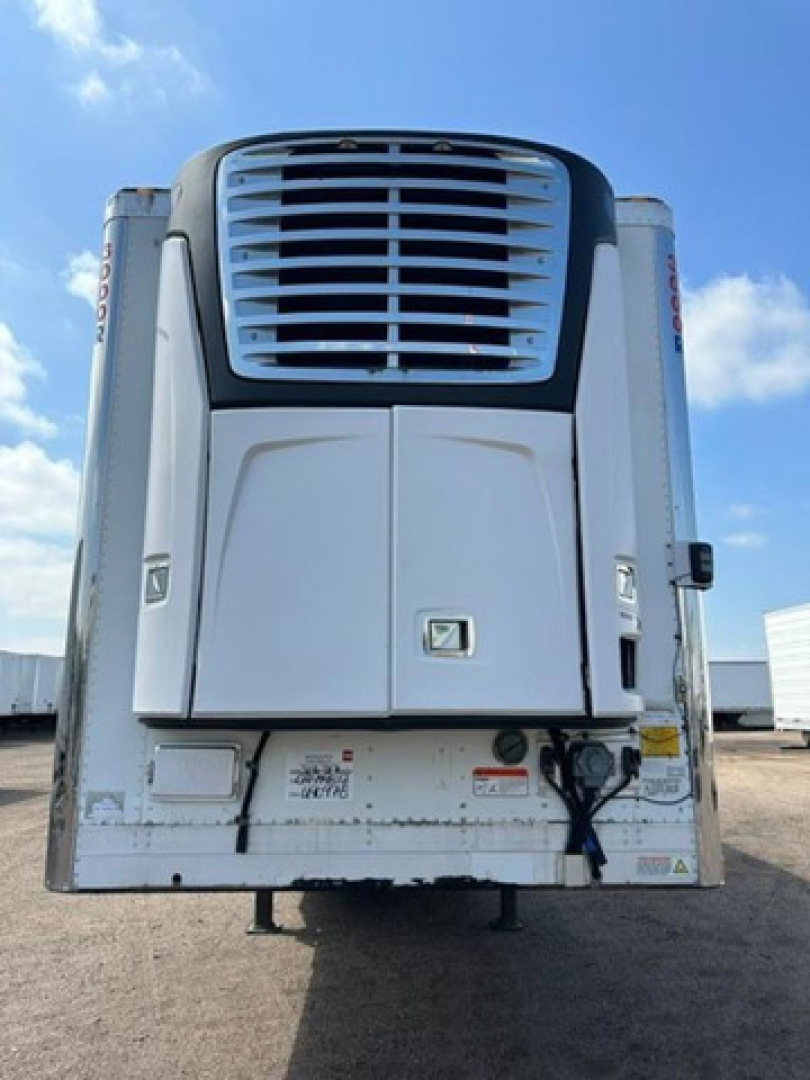 Utility reefer trailer rear view showing white refrigerator unit with grille and access doors.