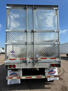 Rear view of 2016 utility refrigerated trailer showing diamond plate doors and reflectors.
