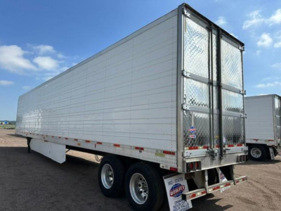 Trailer side view showing 2016 Utility Reefer refrigerated trailer with aluminum panels and dual rear doors.