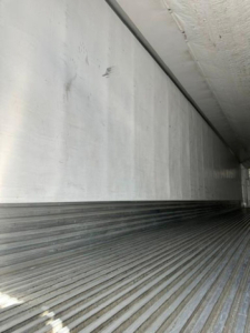 Trailer interior showing ribbed floor and side wall of a 2016 utility reefer trailer.
