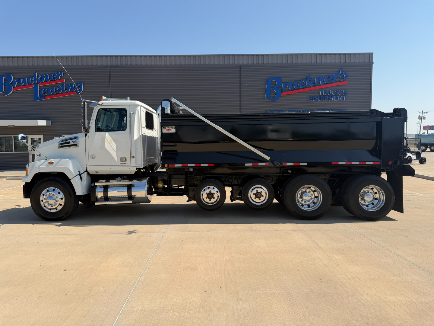 2017 Western Star 4700SF dump truck side view showing long chassis and dump bed.